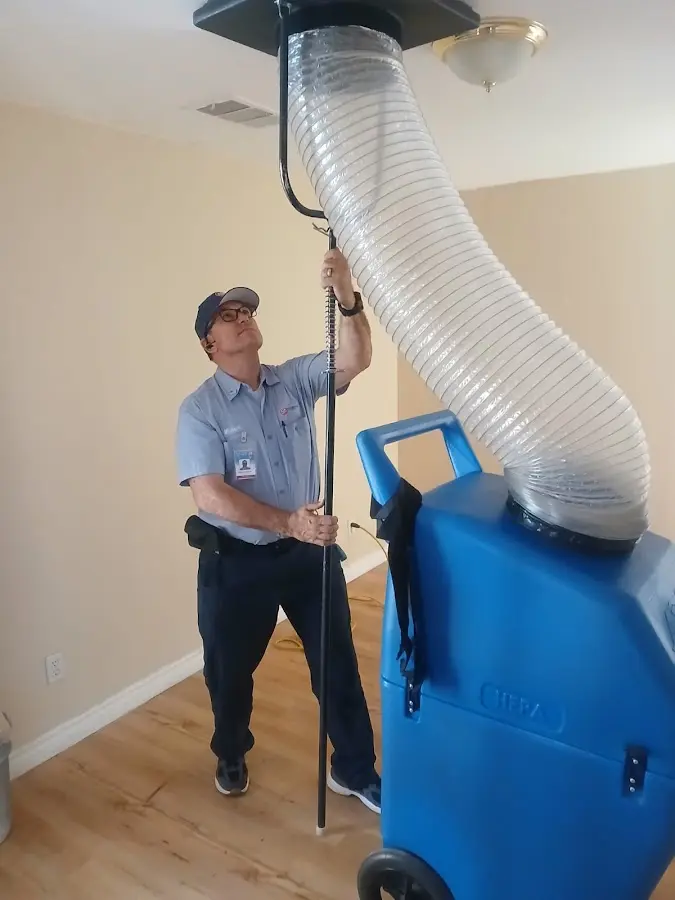 Furnace Tune-Up technician using HEPA equipment in Leesburg